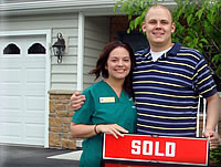 Photo of happy couple after settling on their new home. Photo of a happy couple after purchasing their new home.