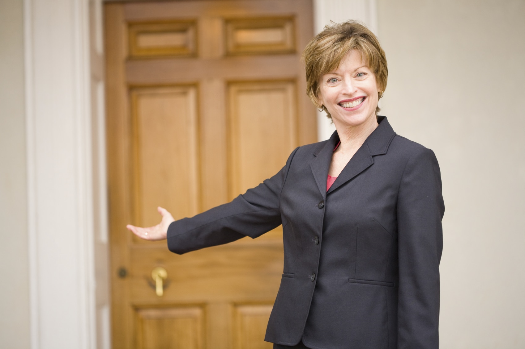Lady gesturing to door