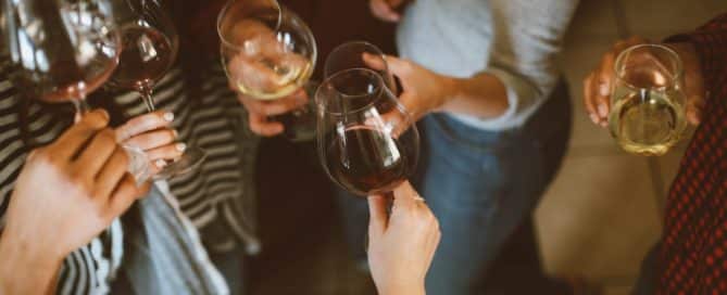 people toasting with wine glasses