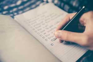 Person making a checklist in a journal