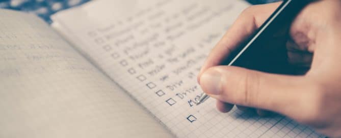 Person making a checklist in a journal