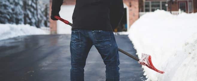 Person shoveling snow off their driveway
