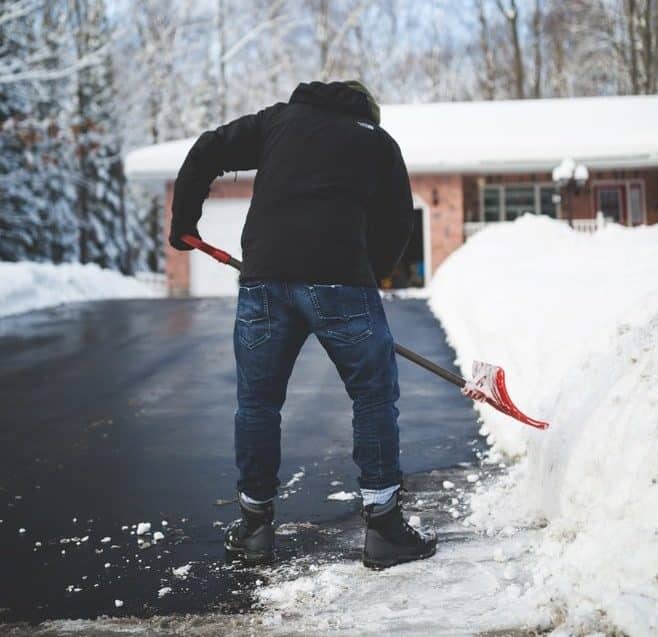 Person shoveling snow off their driveway
