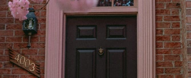 Front door with blooming pink flowers