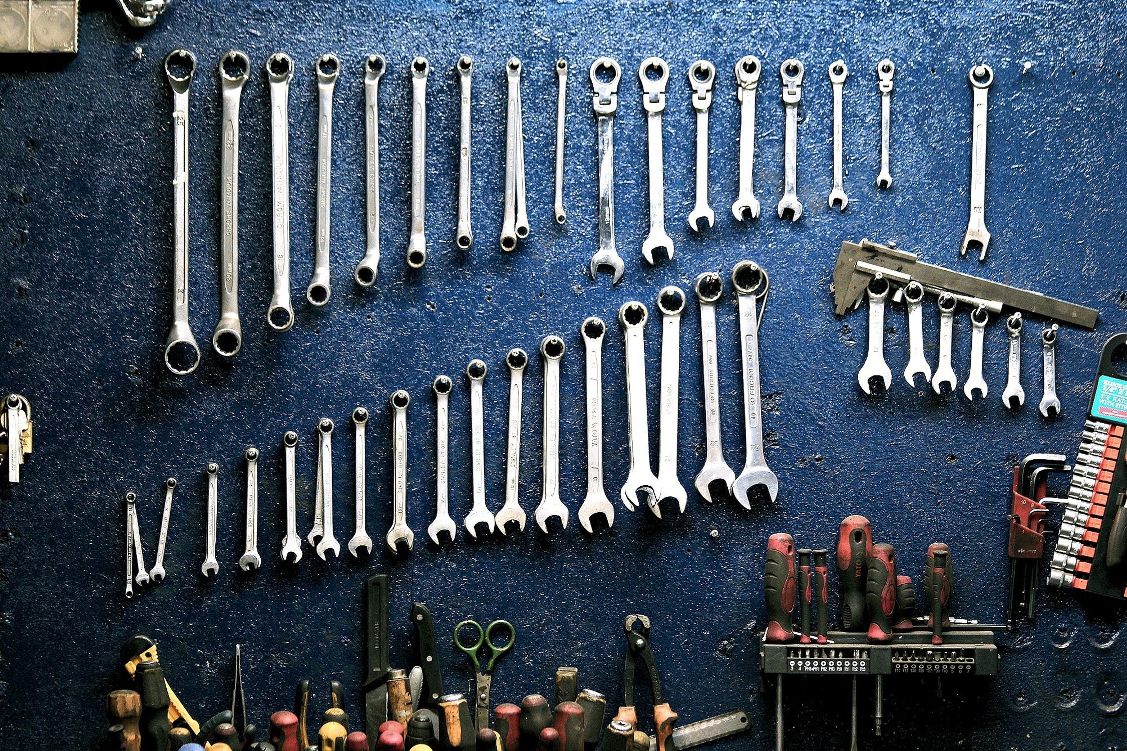 Neatly organized wrenches on the wall