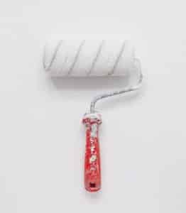Paint roller covered in white paint