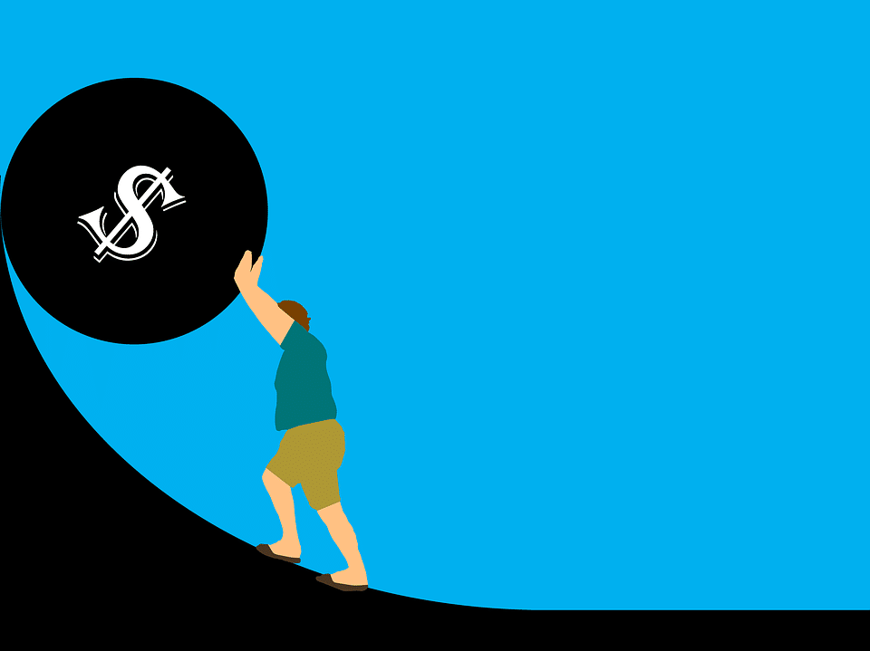 Man pushing boulder with dollar sign on it up a steep hill