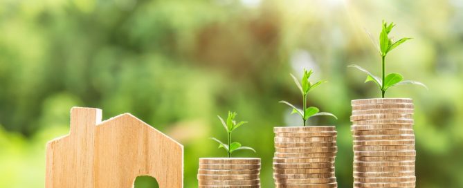 Increasing stacks of coins with sprouts growing out the top