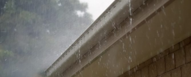 heavy rain pouring over a gutter