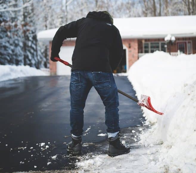 Person shoveling snow off their driveway