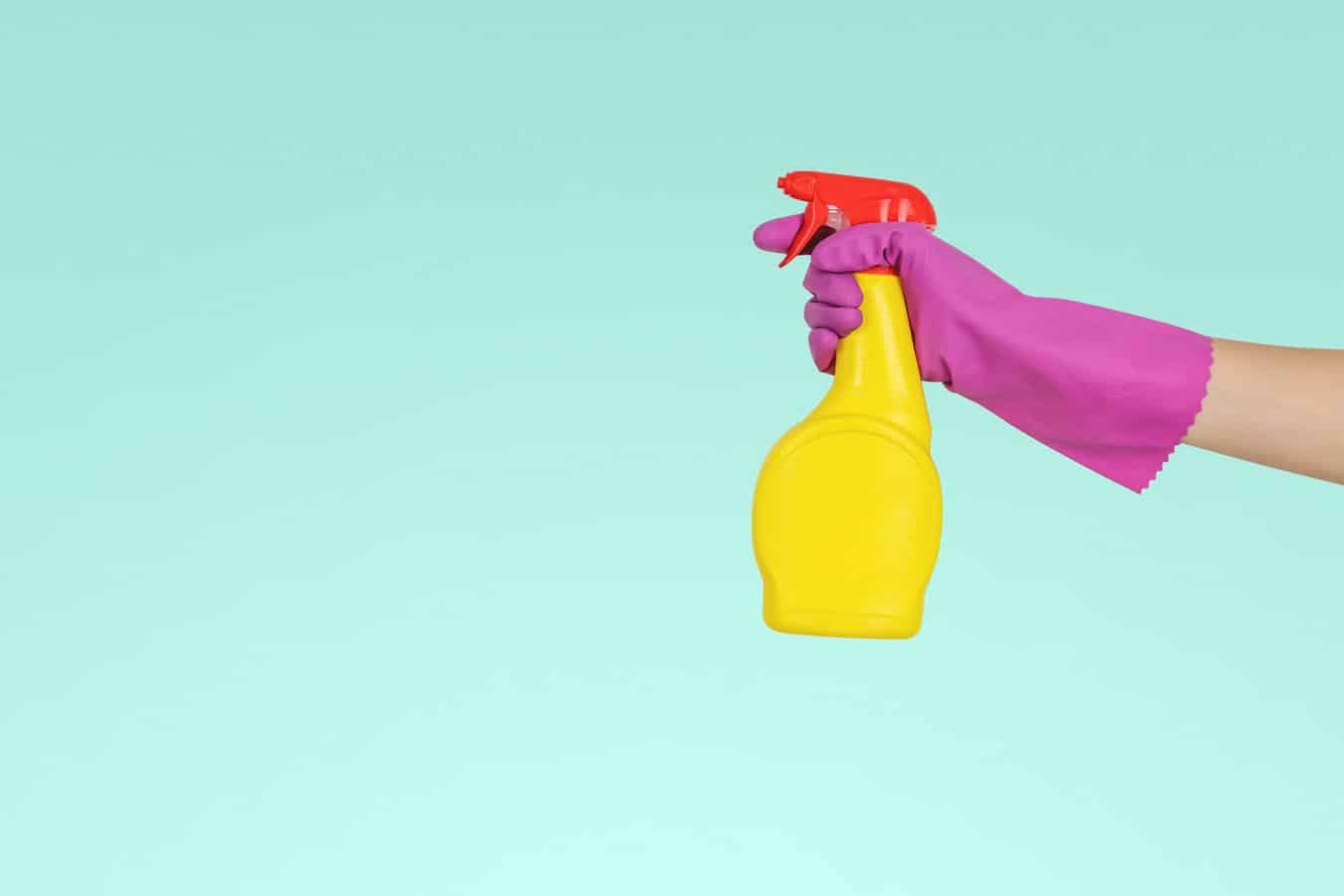 Rubber Gloved hand with spray bottle