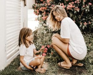 woman and child looking at flowers