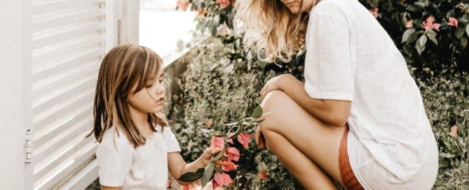 woman and child looking at flowers