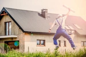 contractor jumping in front of house