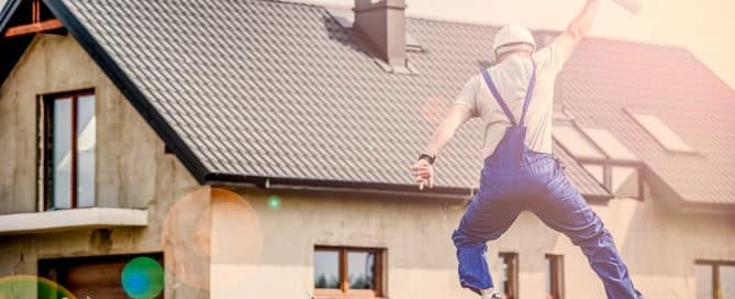 contractor jumping in front of house