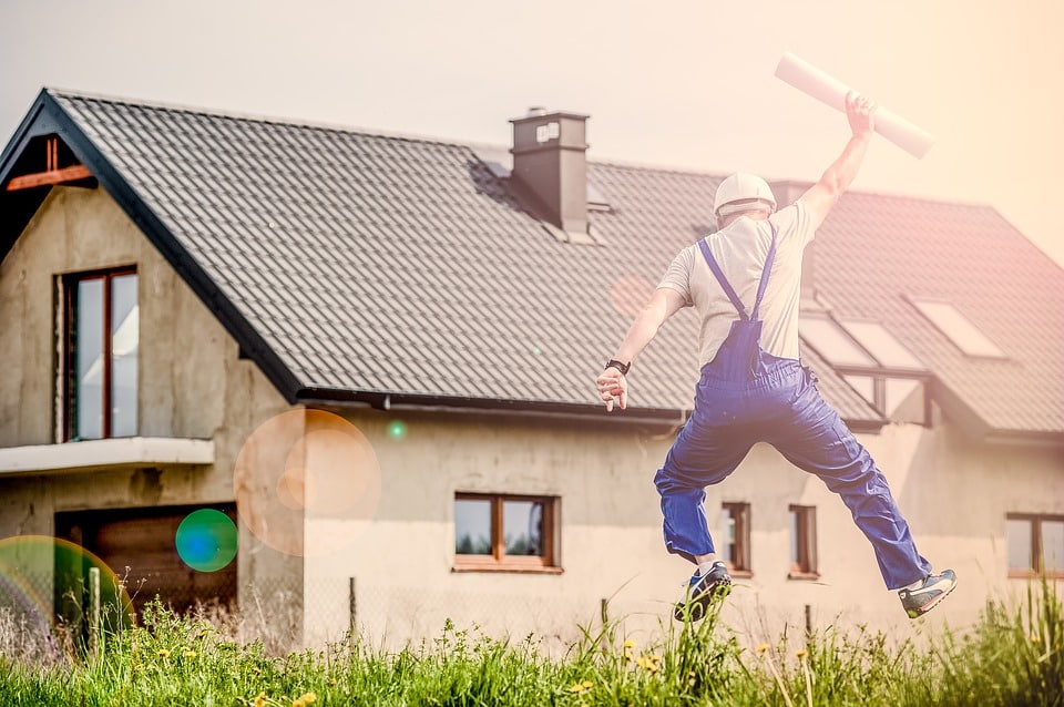 contractor jumping in front of house