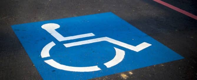 Handicap parking sign on pavement
