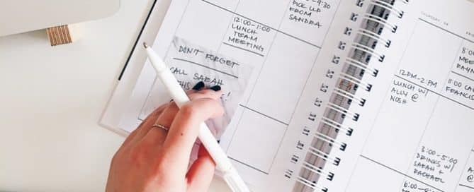 person writing in a planner