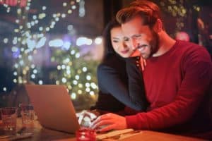 couple smiling at a laptop