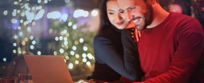 couple smiling at a laptop