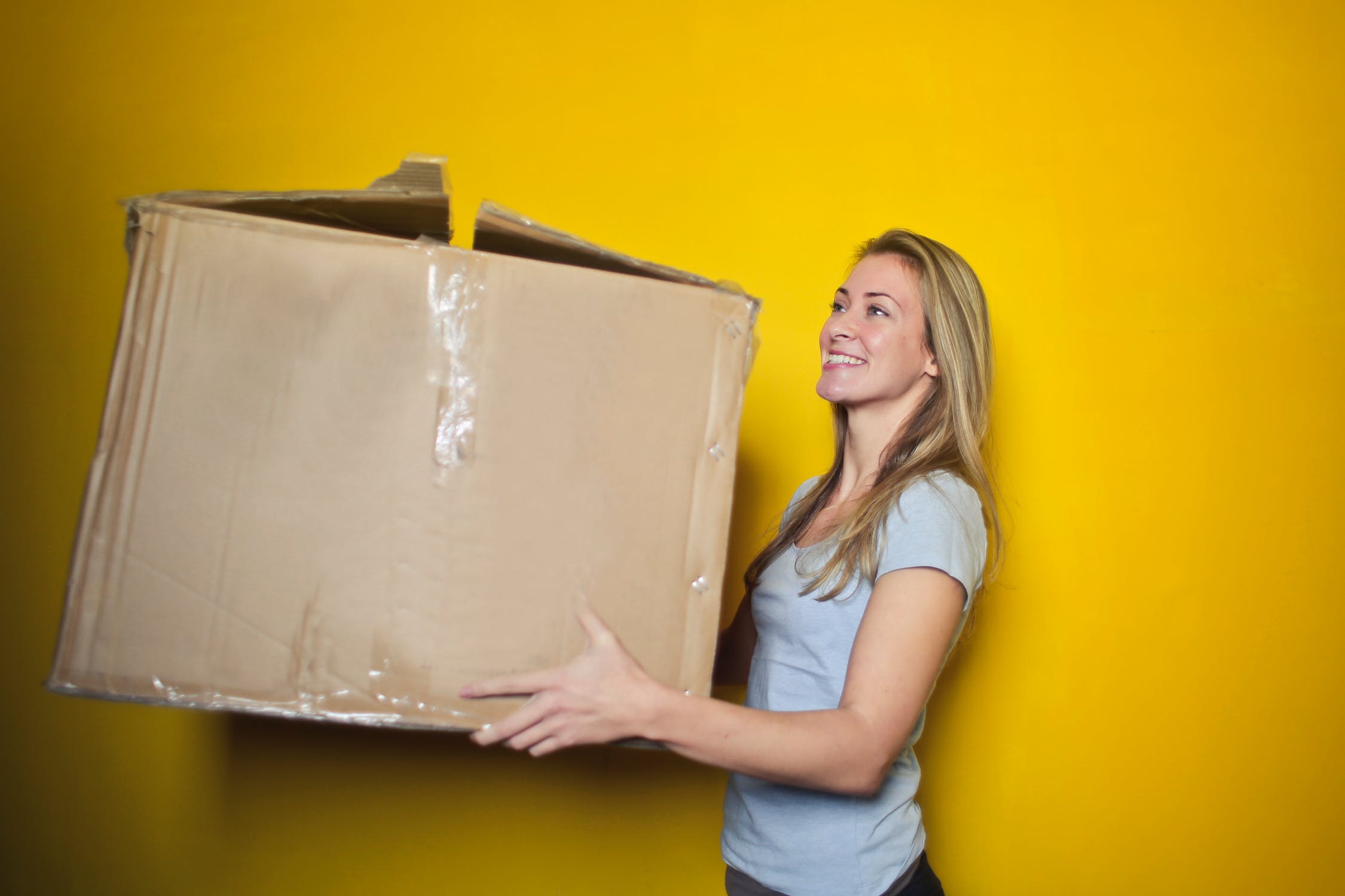 woman holding cardboard box