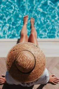 Woman hanging her feet in the pool