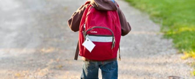 kid walking down driveway to go to school