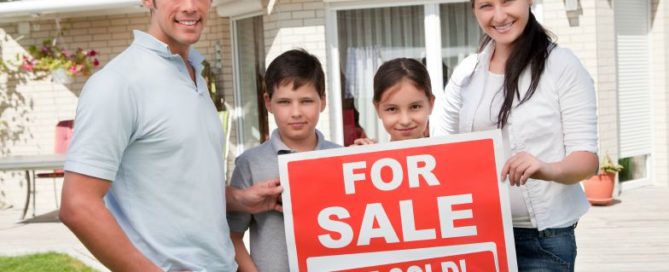 Family with for sale, just sold sign
