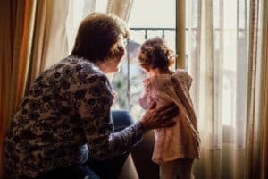 Grandma and granddaughter looking out the window