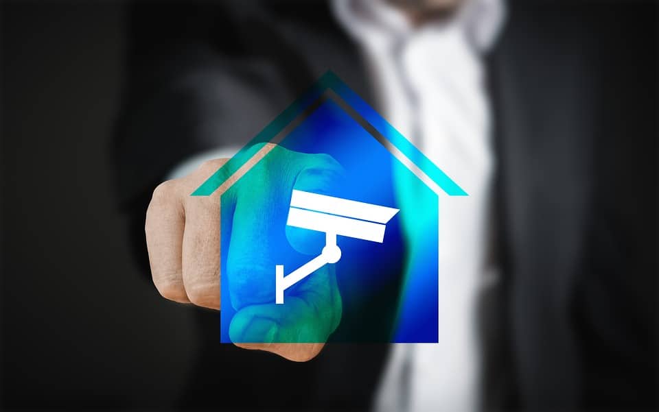Person selecting a home security icon