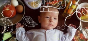 Baby surrounded by produce