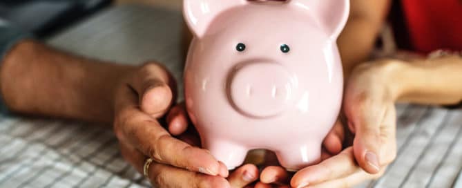 People holding piggy bank